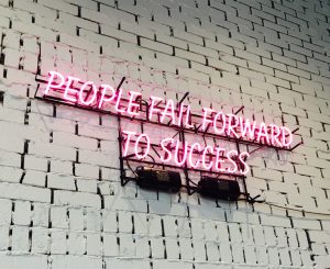 Neon wall art says people fail forward to success